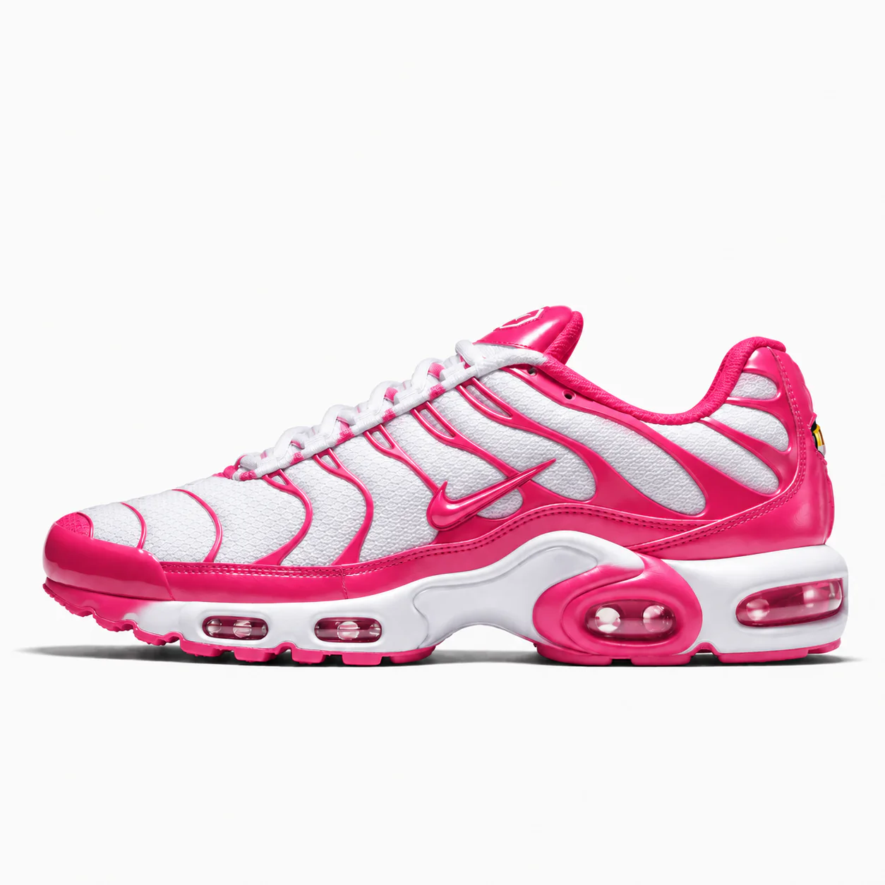 Nike Air Max Plus in white, hot pink, side view of the sneaker on a white background.